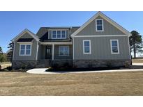 Charming home with stylish board and batten siding, stone accents, and a welcoming front porch at 35 Wheatfield Ln, Youngsville, NC 27596