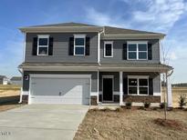 Charming two-story home with gray siding and a spacious two-car garage at 55 E Victory View. Ter, Smithfield, NC 27577