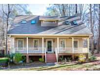 Charming home with a welcoming front porch, skylights, and mature trees at 8116 Reynard Rd, Chapel Hill, NC 27516