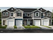 Charming townhome with multiple units, showcasing individual garages and a welcoming facade at 10523 Brookside Reserve Rd, Raleigh, NC 27614