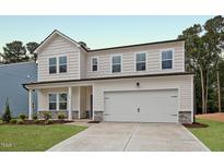 Charming two-story home with white siding, stone accents and a two car garage at 1229 Dimaggio Dr # 8, Raleigh, NC 27616