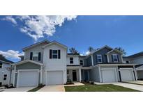 Inviting townhomes feature attached garages, neutral paint, and well-manicured lawns at 144 Parker Ln, Mebane, NC 27302