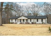 Charming white brick home with a dark roof, offering a blend of classic design and modern appeal at 206 Ellington Rd, Graham, NC 27253