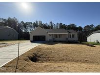 Charming single story home with neutral siding and a large front yard in a new neighborhood at 275 Magnolia Run Way, Benson, NC 27504