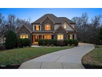 Charming stone and siding home with inviting front yard and long driveway at 2933 Elmfield St, Raleigh, NC 27614