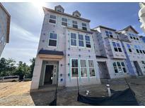 New construction townhome featuring multiple windows and durable weather resistant wrap at 315 Chesapeake Commons St # 102, Garner, NC 27529
