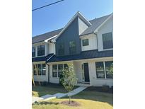 Modern townhome featuring a brick facade and a mix of dark and light siding and black window frames at 344 Church St, Morrisville, NC 27560