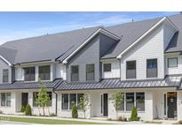 Beautiful townhouse with white brick and gray siding, complemented by well-maintained landscaping at 344 Church St, Morrisville, NC 27560