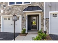 Inviting front entrance featuring a stone facade and a stylish black door with transom window at 509 Sherron Rd # 22, Durham, NC 27703