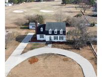 Charming two-story home with a circular driveway on a lush lot backing up to a golf course at 849 Jeffreys Rd, Rocky Mount, NC 27804