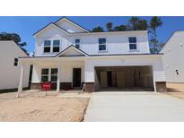 New construction two-story home with a large garage, white siding and brick foundation at 1233 Dimaggio Dr # 7, Raleigh, NC 27616