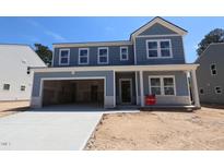 Beautiful two-story home with a large garage and light blue siding at 1240 Dimaggio Dr # 35, Raleigh, NC 27616