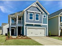 Charming two-story home with a two-car garage and a covered porch offers curb appeal at 21 Nimble Way # 176, Clayton, NC 27520