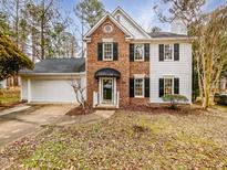 Charming two-story brick and siding home with a well-manicured lawn and attached two car garage at 3604 Tunas St, Raleigh, NC 27616