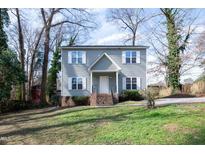 Charming two-story home with muted siding, white trim, landscaped yard, and inviting front entrance at 3883 Pin Oak Rd, Raleigh, NC 27604