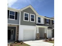 Charming townhouse exterior with gray siding, white trim, and a one-car garage on a sunny day at 6132 Arsenal Ave, Raleigh, NC 27610