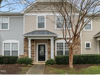 Charming townhome with stone accents, neutral siding, and a well-maintained front yard with mature landscaping at 11425 Shadow Elms Ln, Raleigh, NC 27614