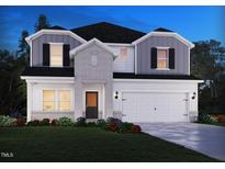 Charming two-story home boasts stone accents and a two-car garage with a beautifully landscaped front yard at 1775 Pie Filling Dr, Haw River, NC 27258