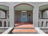 Charming front porch with brick accents and a blue front door, creating a welcoming entrance at 2311 N Roxboro St, Durham, NC 27704