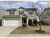 Charming two-story home features a two-car garage and inviting front yard at 2522 Dalmahoy Ln, Fuquay Varina, NC 27526