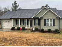 Charming single-story home with a garage, a front yard, and traditional curb appeal at 421 Angus Pl, Stem, NC 27581