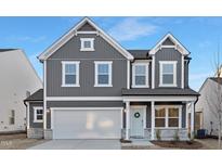 Charming two-story home featuring a two-car garage, stylish gray siding, and welcoming blue front door at 43 Mable Court # 4, Lillington, NC 27546