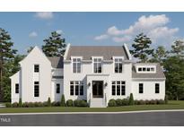 Elegant two-story home featuring painted brick, a symmetrical facade, and lush landscaping at 6844 Greystone Dr, Raleigh, NC 27615