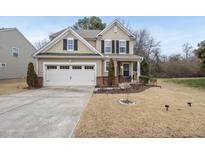 Charming two-story home featuring a two-car garage and a well-maintained lawn at 909 Pleasant Colony Dr, Knightdale, NC 27545