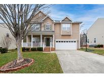 Charming two-story home featuring a welcoming porch and attached two-car garage at 940 Fulworth Ave, Wake Forest, NC 27587