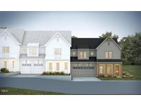 Charming two-story townhomes with a farmhouse-style design, featuring a one-car garage and beautifully landscaped yards at 1009 Coldspring Circle, Durham, NC 27705