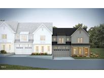 New construction townhome showcasing traditional design with light-colored facade, prominent windows, and attached garages at 1015 Coldspring Circle, Durham, NC 27705