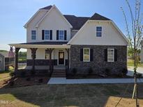 Beautiful two-story home with a covered porch and stone accents at 1021 Prominence Dr., Homesite 20, Durham, NC 27712