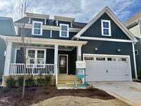 Charming two-story home with a covered front porch and a two-car garage at 1205 Porters Call Dr, Wendell, NC 27591