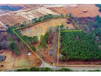 Expansive aerial view of property lines showcasing land, trees, and nearby road at 2502 Devils Racetrack Rd, Four Oaks, NC 27524