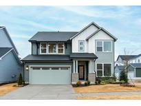 Charming two-story home with a gray exterior, attached garage, and well-manicured front yard at 2506 Gordal Trl, New Hill, NC 27562