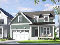 Charming two-story home boasts a welcoming front porch and attached garage at 264 Big Bradley Dr, Wendell, NC 27591