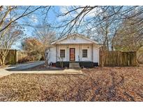 Charming white cottage with black porch and a well-maintained yard at 308 Williamson St, Burlington, NC 27215