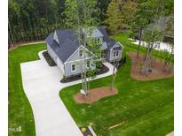 New construction home featuring a landscaped yard, long driveway, and gray siding at 3909 Cedar Knolls Dr # 6, Youngsville, NC 27596