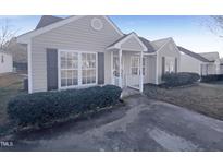 Charming single-story home with a cozy porch, landscaped bushes, and a welcoming entrance at 5128 Julip Dr, Knightdale, NC 27545