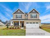 Charming two-story home with a manicured lawn, two-car garage, and welcoming front porch at 5386 Salem Woods Dr # 17, Graham, NC 27253