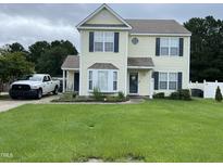 Charming two-story home with a well-manicured lawn and inviting curb appeal with attractive shutters at 711 Weathervane Way, Rocky Mount, NC 27803
