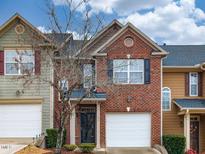 Charming brick townhome features a one-car garage and well-maintained landscaping at 102 Forrymast Trl, Apex, NC 27539