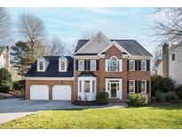 Charming brick home with a well-manicured lawn and two-car garage, offering classic curb appeal at 102 Seabreeze Ct, Cary, NC 27513