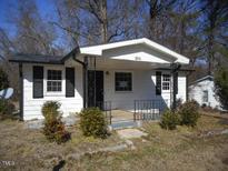 Charming single-story home featuring a quaint front porch and well-placed shrubbery at 106 W Allen St, Four Oaks, NC 27524