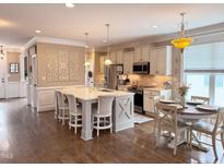 Spacious kitchen featuring a large island with seating and modern appliances, perfect for entertaining at 1117 Golden Star Way, Wake Forest, NC 27587