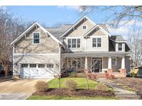 Charming two-story home with a well-manicured lawn and inviting front porch, perfect for enjoying the outdoors at 1419 Norton St, Durham, NC 27701