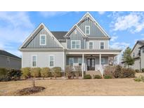 Charming two-story home featuring a welcoming front porch and well-maintained landscaping at 1421 Sweetclover Dr, Wake Forest, NC 27587