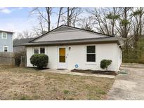 Charming single-story home features a white brick facade and an inviting front entrance at 2305 Fitzgerald Ave, Durham, NC 27707