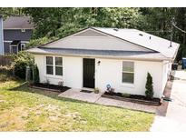 Charming single-story home featuring a newly painted exterior, manicured landscaping, and a welcoming entrance at 2305 Fitzgerald Ave, Durham, NC 27707