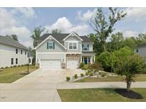 Beautiful two-story home featuring a two-car garage, manicured lawn, and tasteful landscaping at 2981 Thurman Dairy Loop, Wake Forest, NC 27587